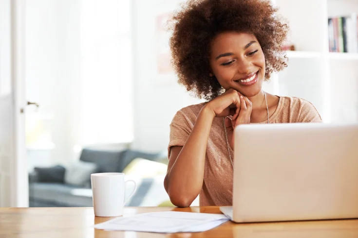 Smiling woman using laptop